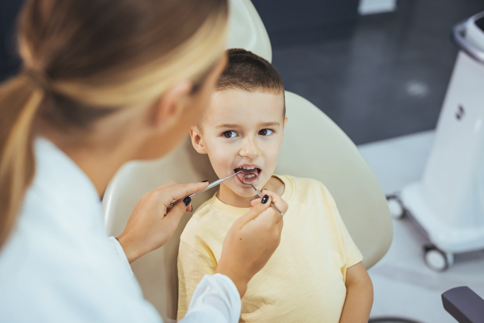 Beautiful boy at the dentist getting a check up on her teeth - pediatrics dental care concepts. Cute little boy getting teeth exam at dental clinic. Dental care, Medical care, Lifestyle, Dental clinic