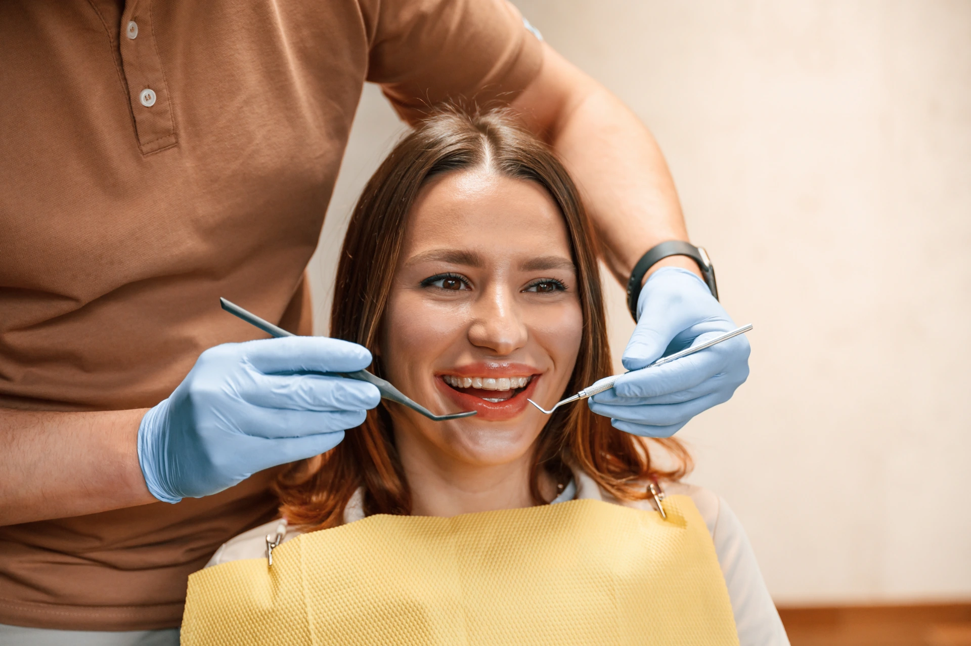 Checking the aligner on teeth. Woman in the stomatology clinic, visiting dentist.