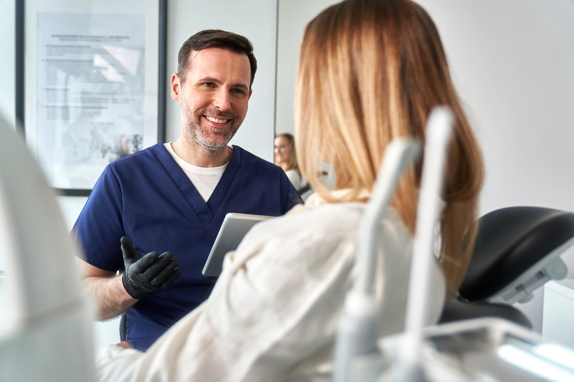 Consultation of the dentist and the patient in the cabinet